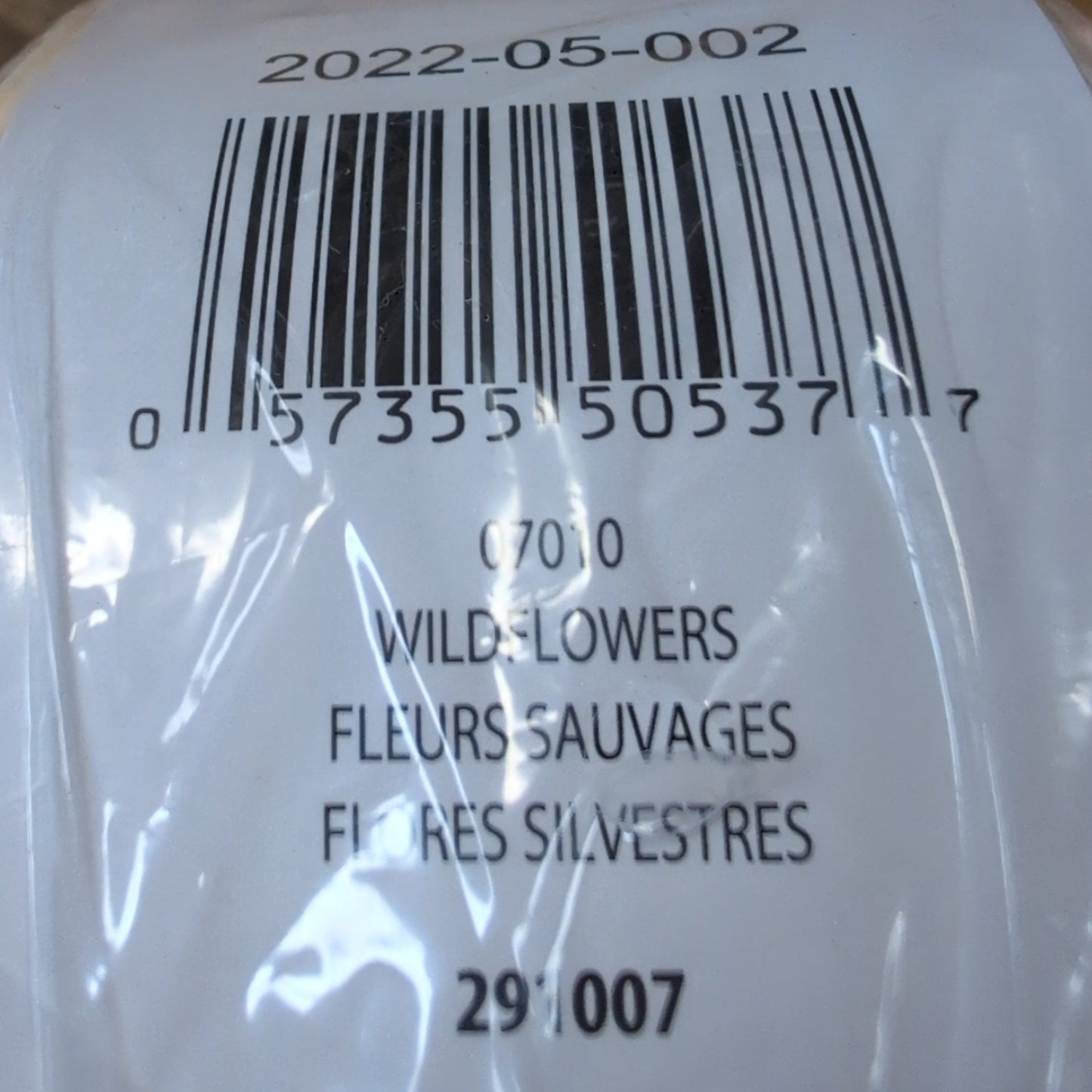Close-up of a product label with a barcode on a wooden surface
