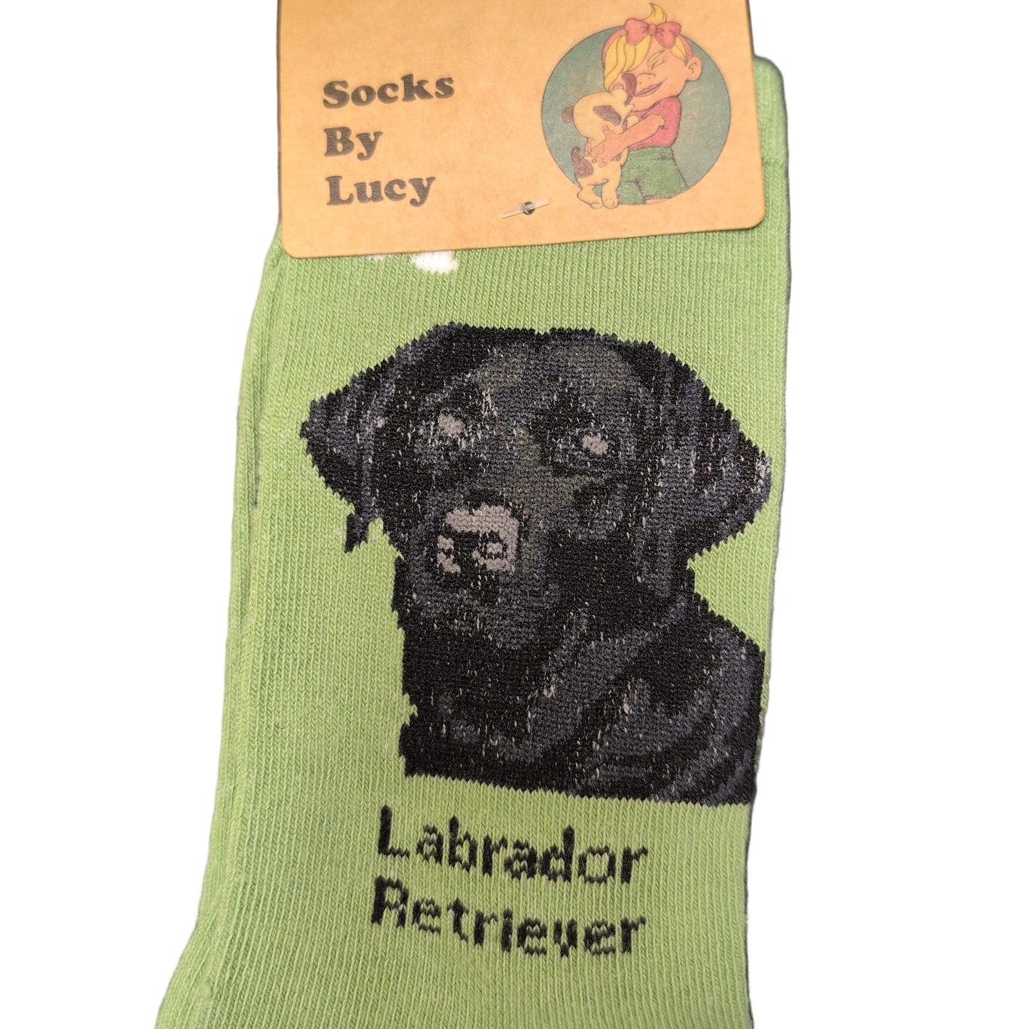 Green sock with black Labrador Retriever design and 'Lucy' branding on a dark surface