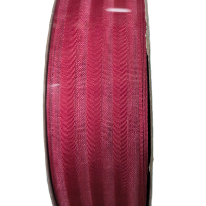 Spool of red ribbon on a white background