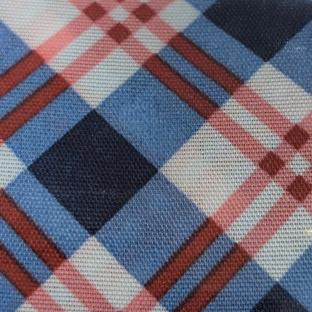 Roll of Kirkland plaid ribbon on a wooden surface