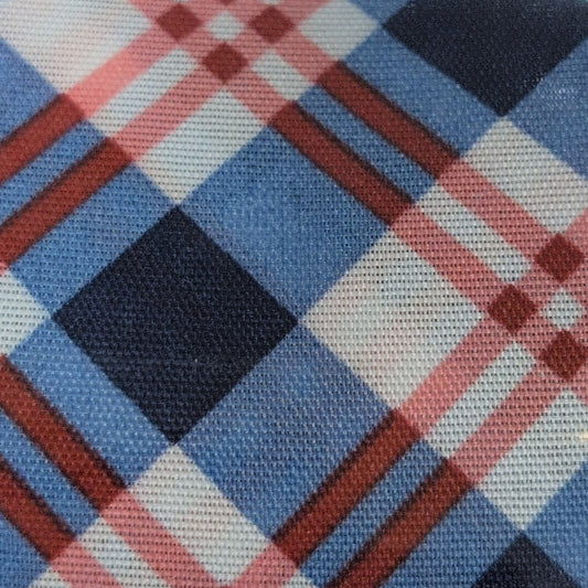 Roll of Kirkland plaid ribbon on a wooden surface