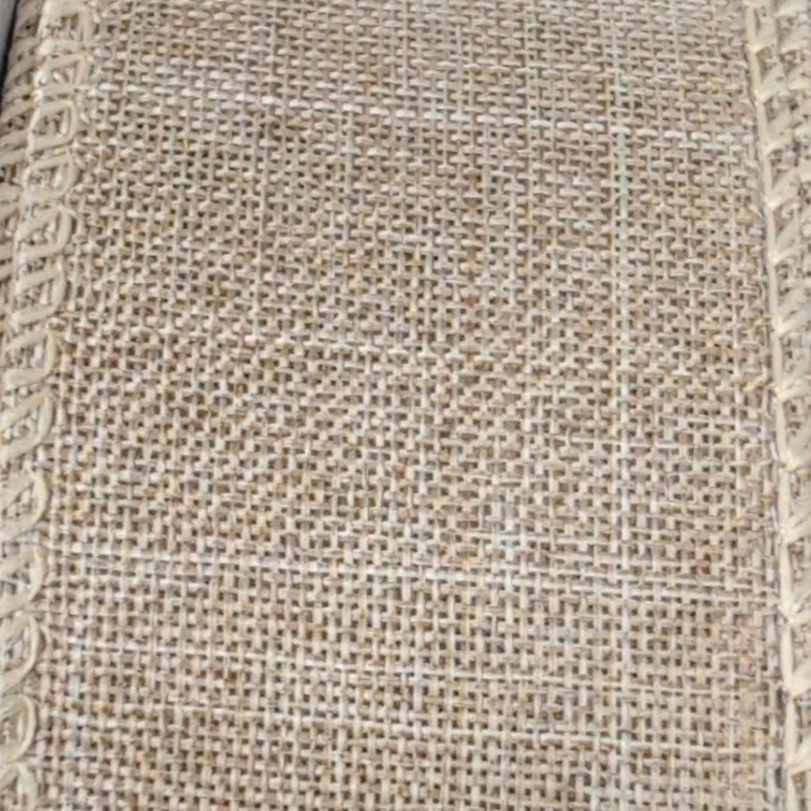 Close-up of textured beige fabric with a subtle pattern