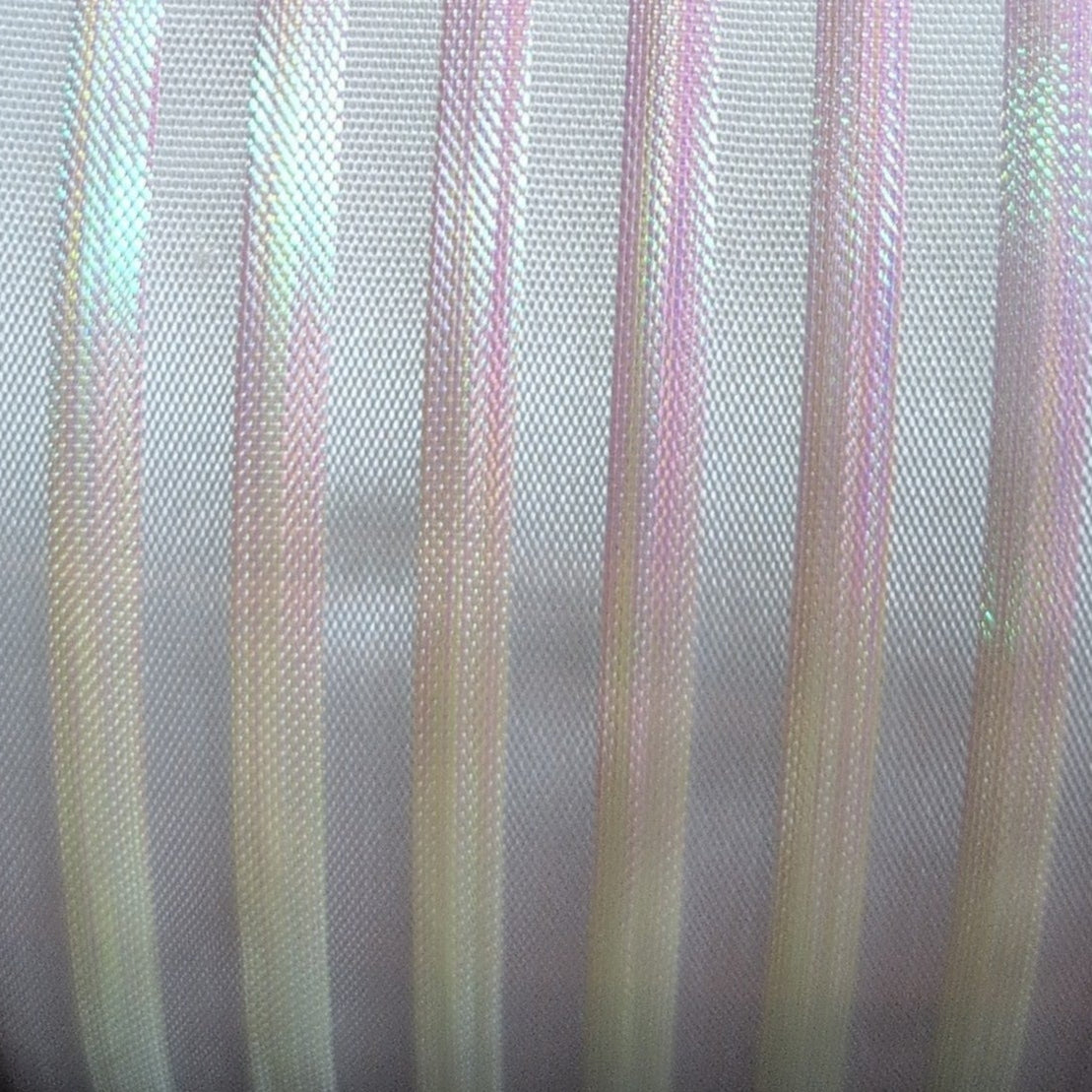 Close-up of fabric with multicolored stripes on a gray background