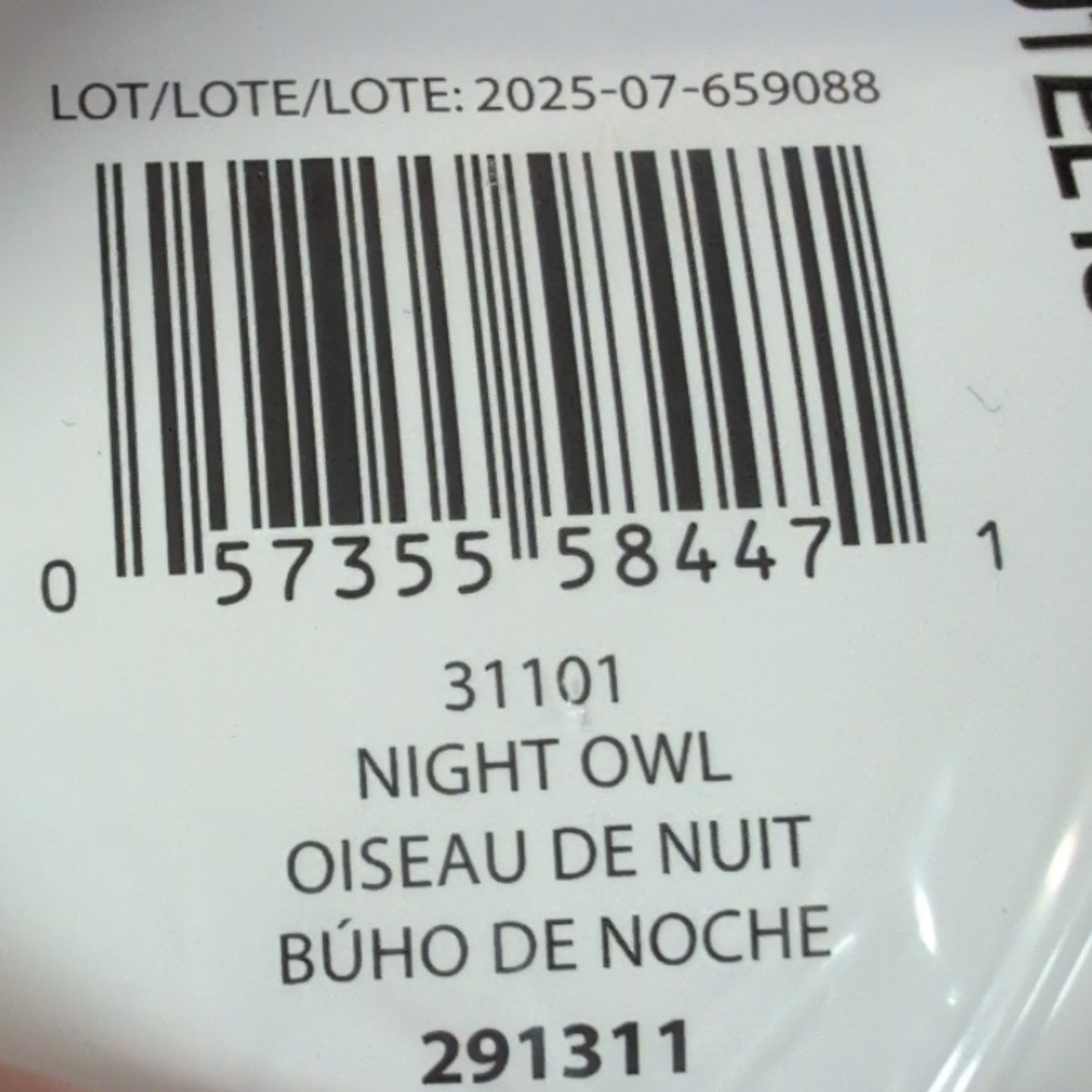 Hand holding a product with a label and barcode