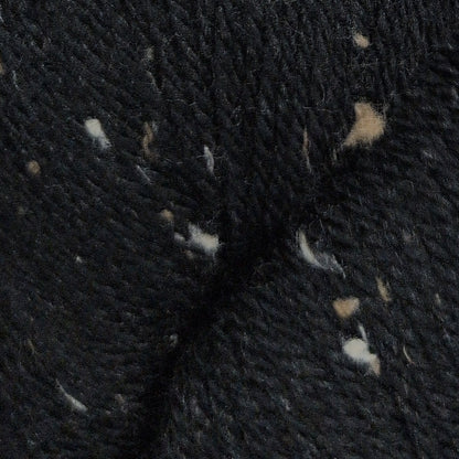 Close-up of dark fabric with small white and beige fibers