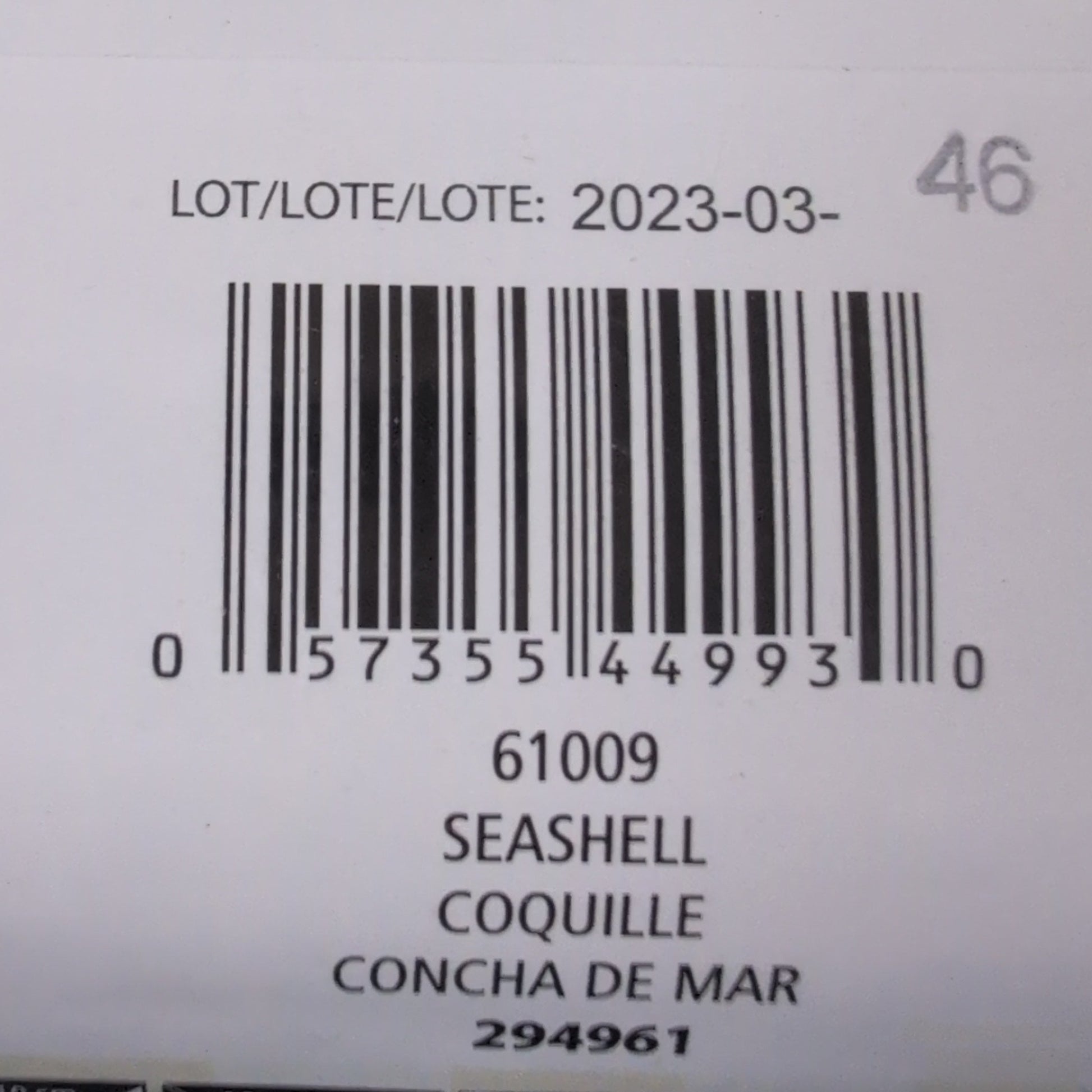 Close-up of a product label with barcodes and text on a textured surface