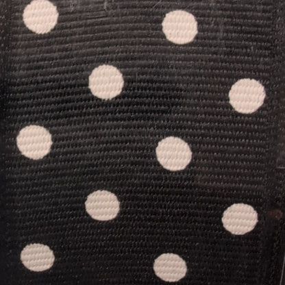Black ribbon with white polka dots in packaging