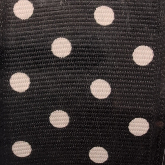 Black ribbon with white polka dots in packaging