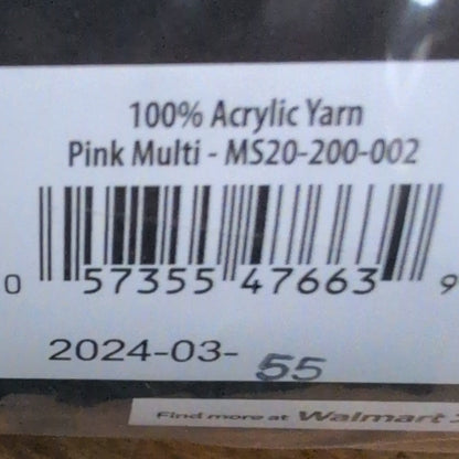 Close-up of a label on a package with text and a barcode, placed on a wooden surface.