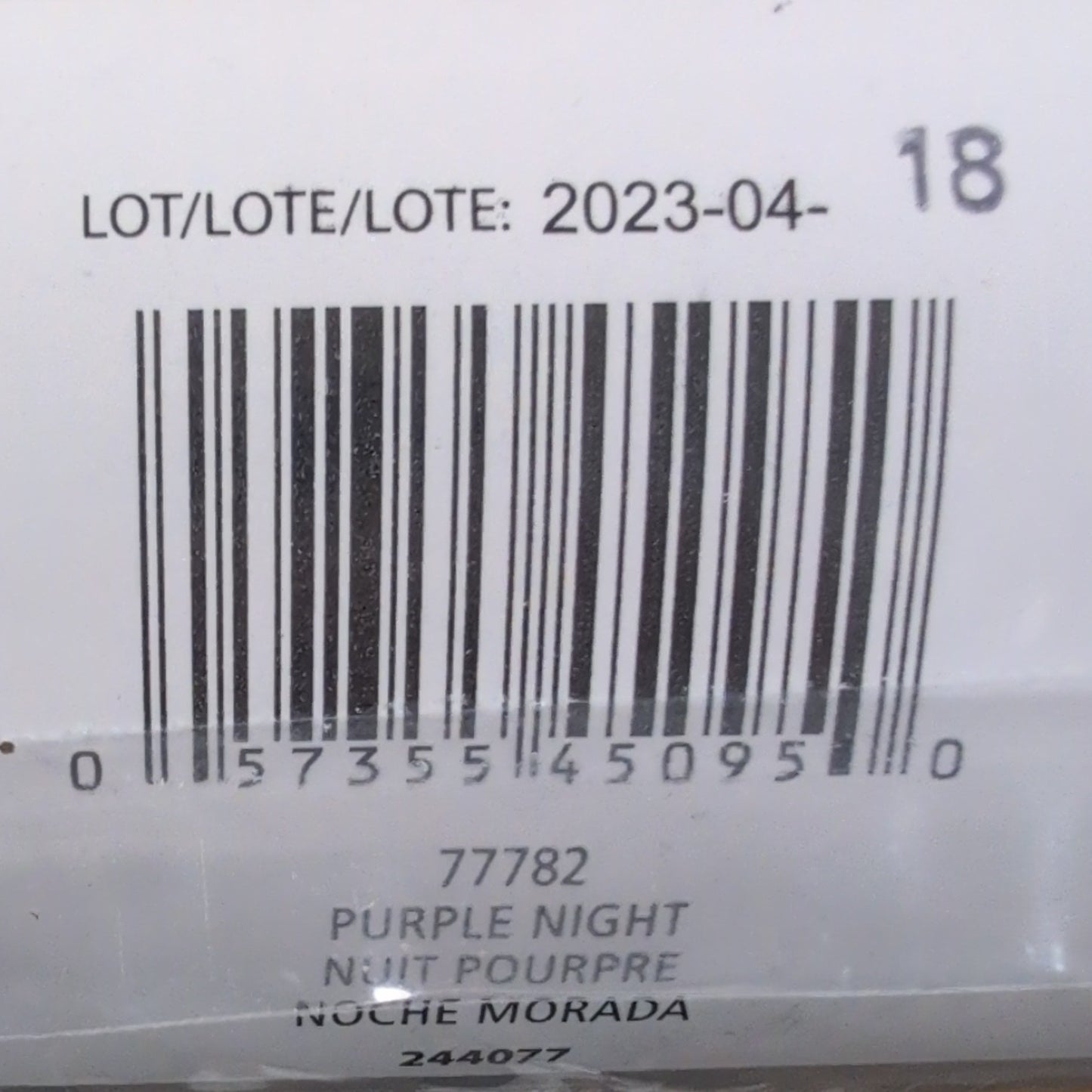 Close-up of a product label with a barcode and text on a blue background.