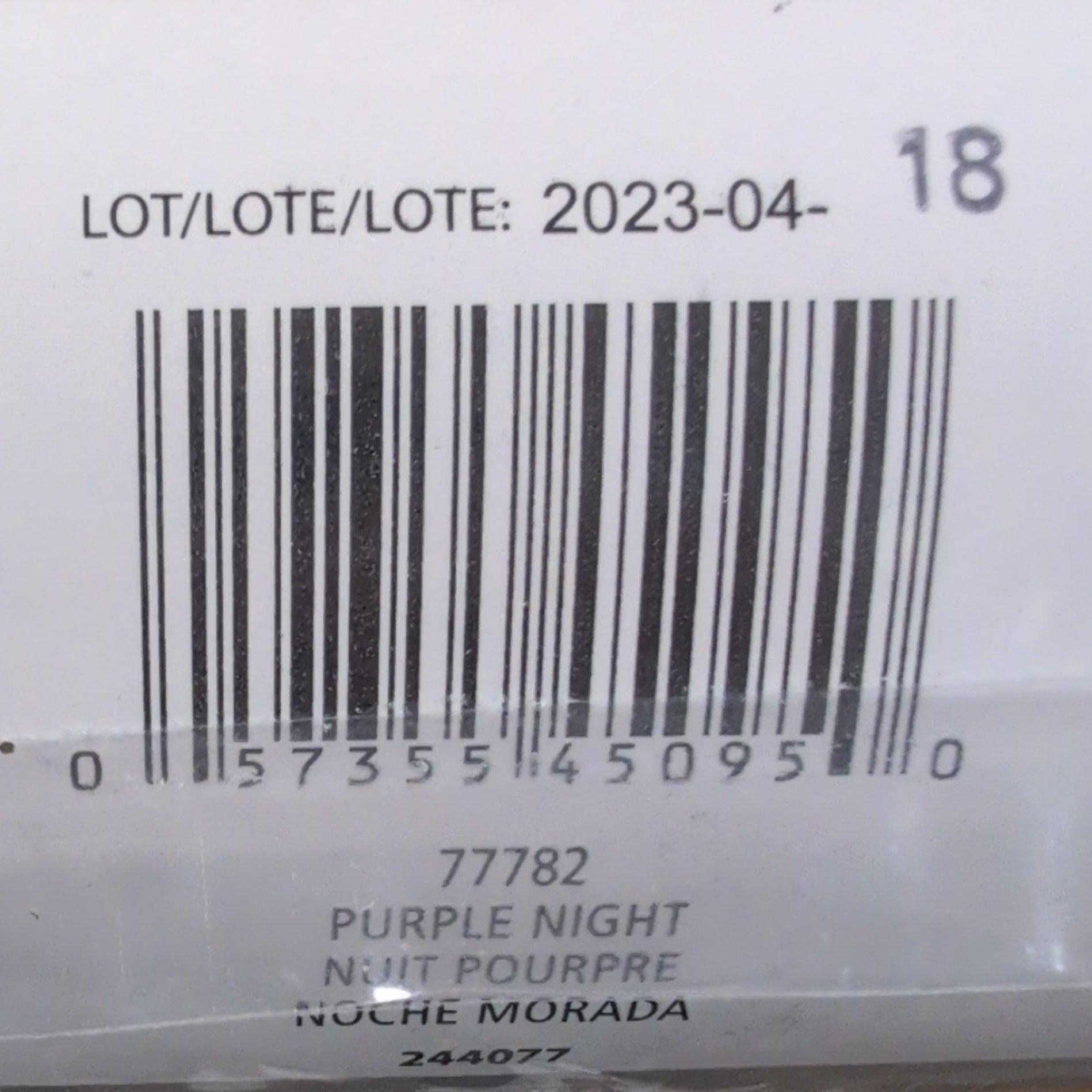 Close-up of a product label with a barcode and text on a blue background.