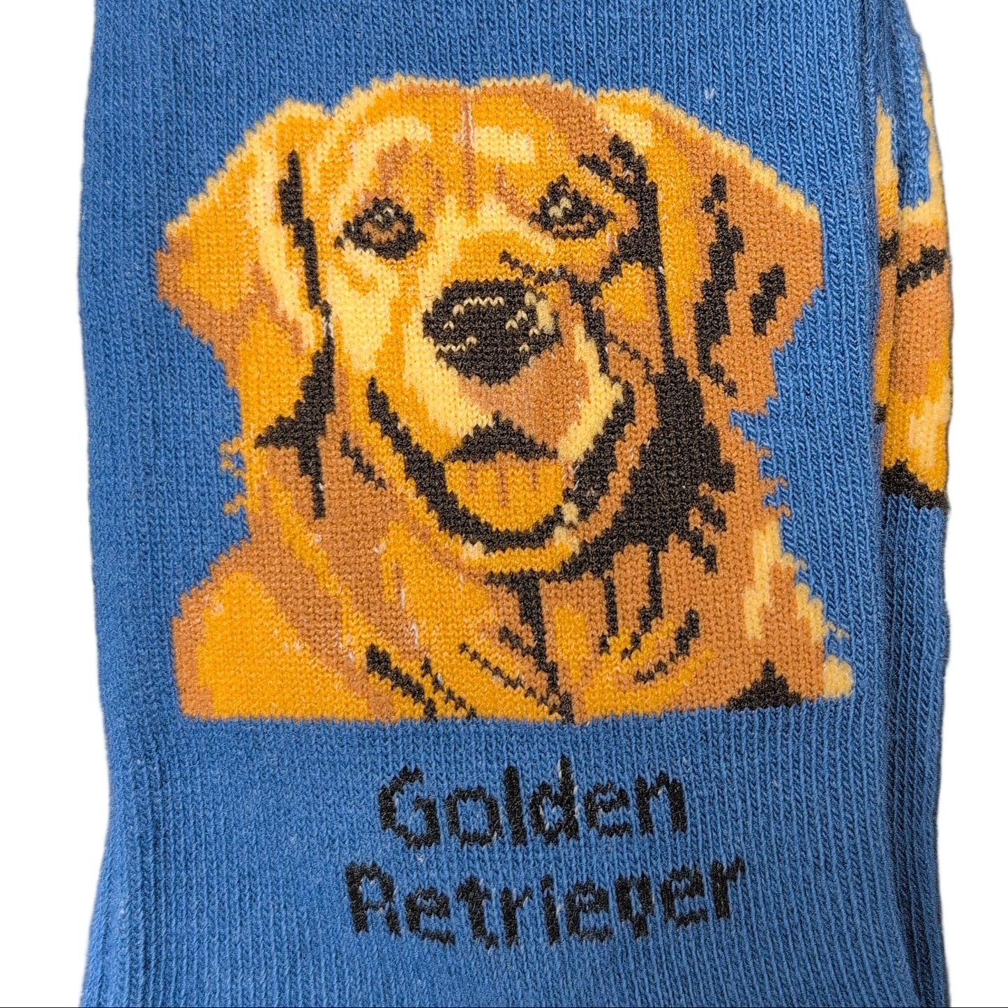 Blue socks with a Golden Retriever design and 'Socks By Lucy' packaging.