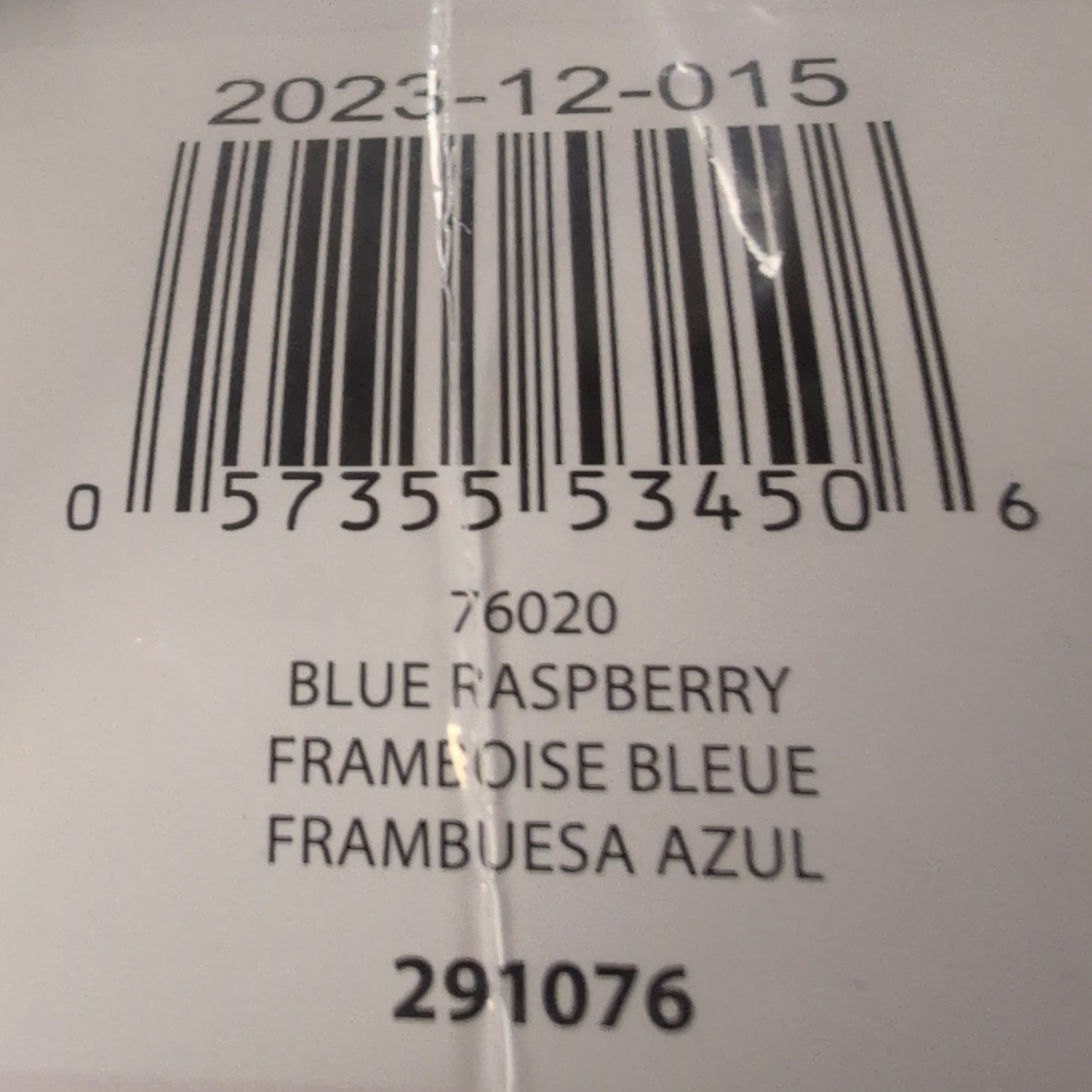 Close-up of a product label with a barcode and text on a blue textured background