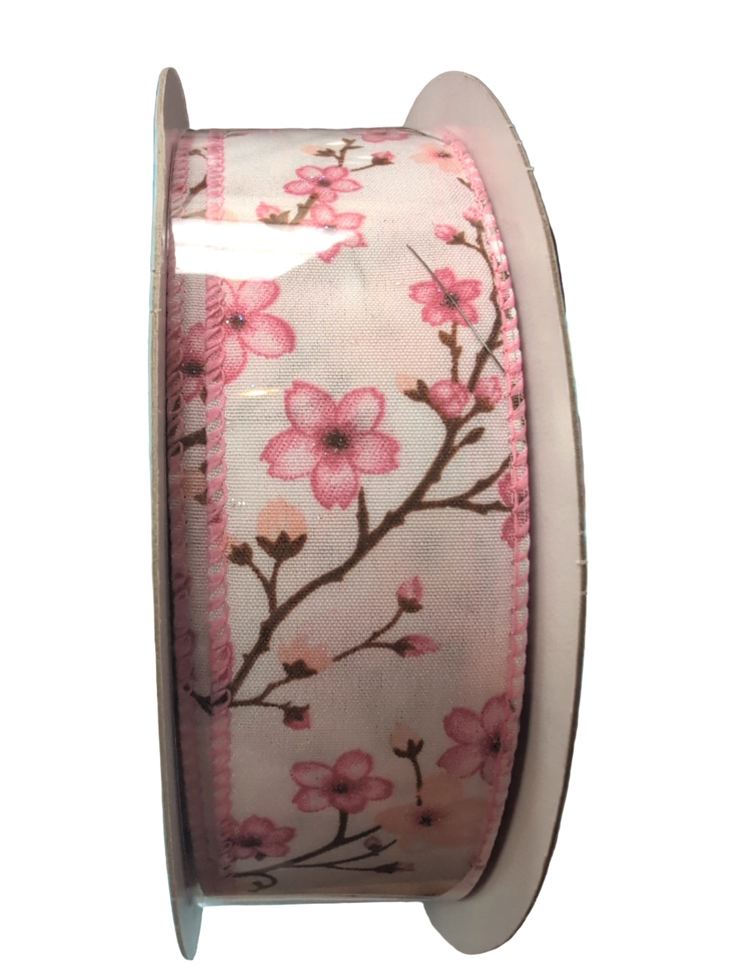 Spool of ribbon with pink floral design on a white background