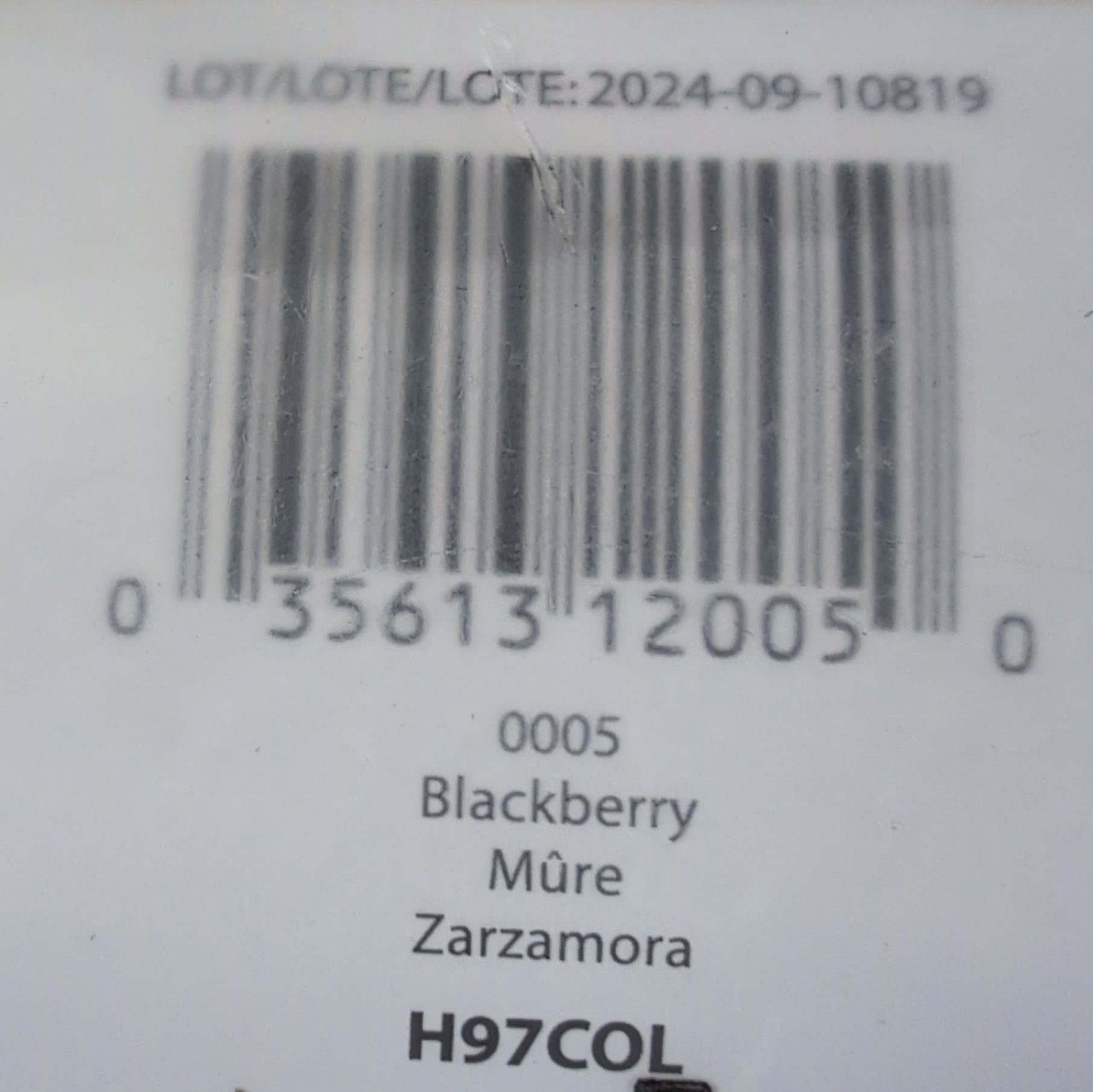 Close-up of a product label with a barcode on a wooden surface