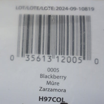 Close-up of a product label with a barcode on a wooden surface