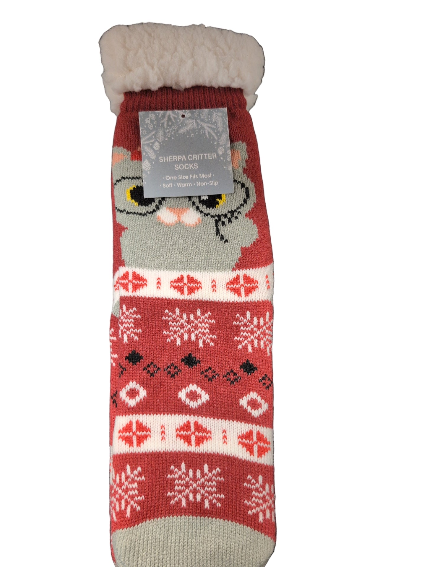 Red knitted scarf with a gray cat design and brand tag on a dark surface