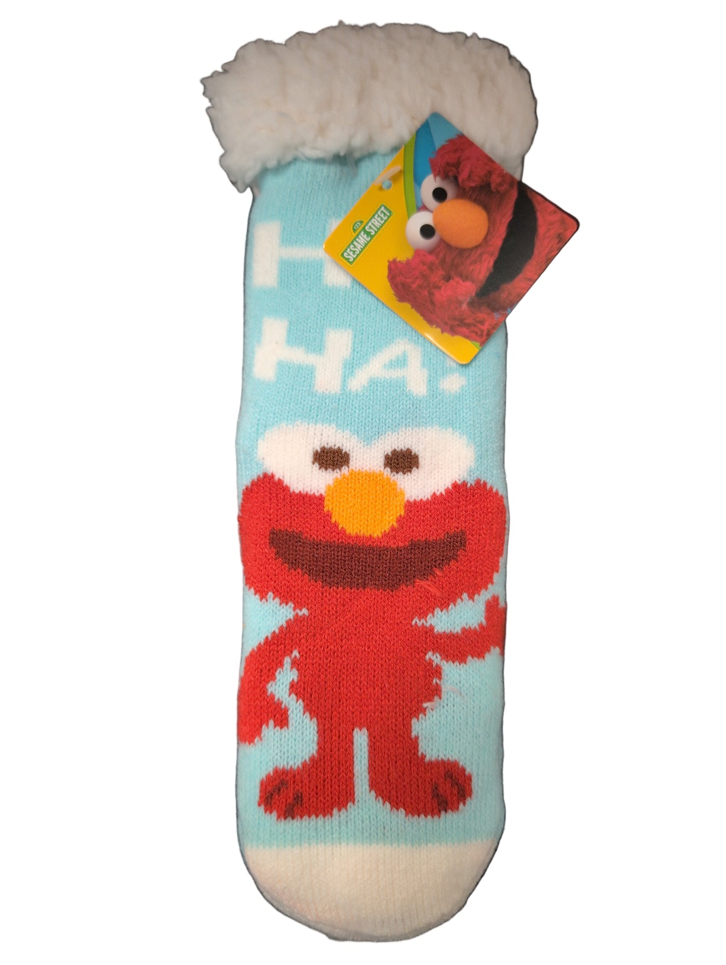 Children's sock with Elmo design and Sesame Street tag on a dark surface