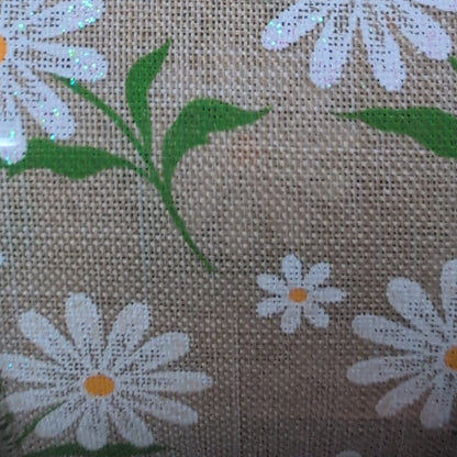 Roll of ribbon with floral pattern on a beige background
