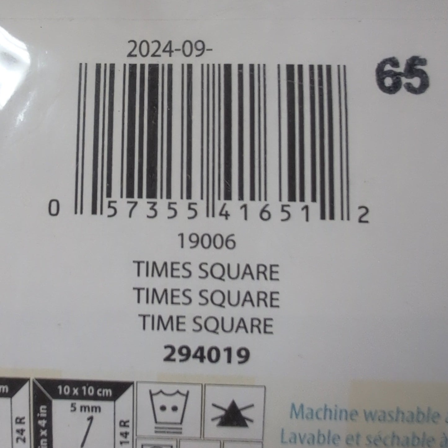 Bar code and label on a product packaging with visible text and symbols.