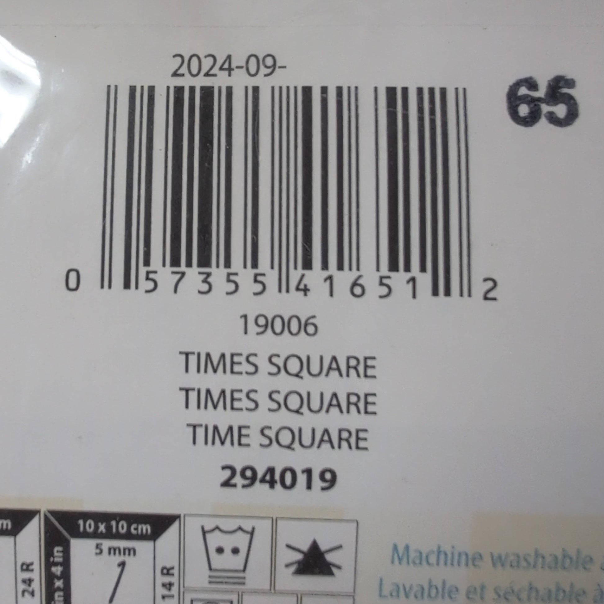 Bar code and label on a product packaging with visible text and symbols.