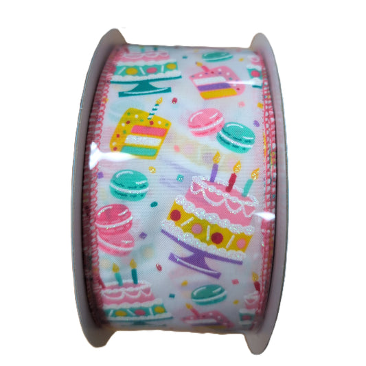 Roll of ribbon with colorful cake and macaron pattern on a white background