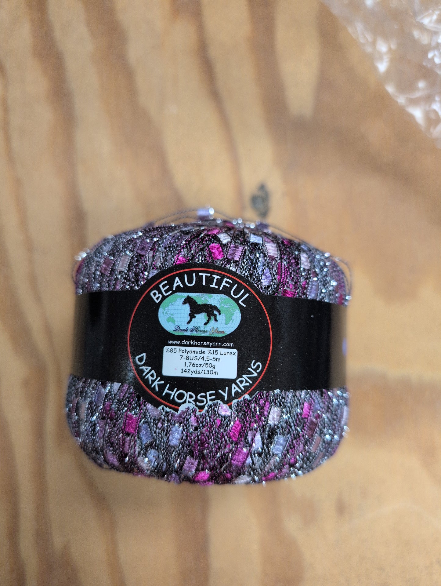Decorative yarn ball with a label on a wooden surface