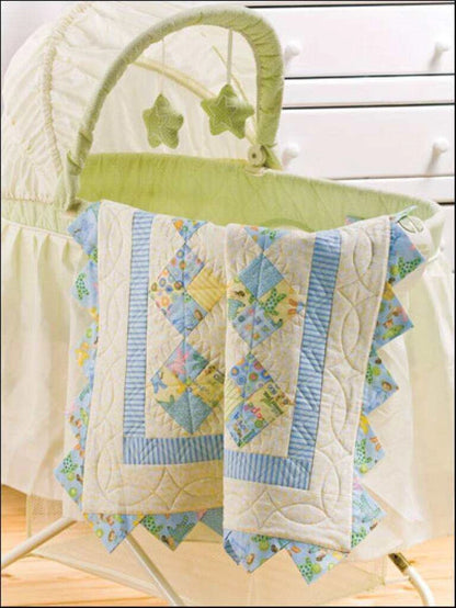 Baby bassinet with a quilt featuring star patterns on a white background