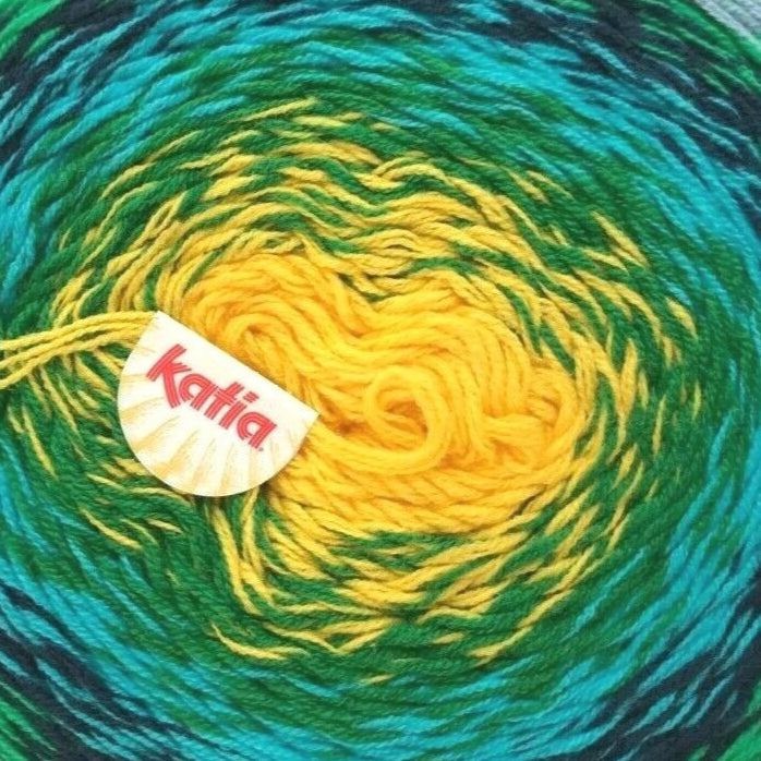 Green and blue skein of yarn with a yellow center, featuring the Kattai brand logo.