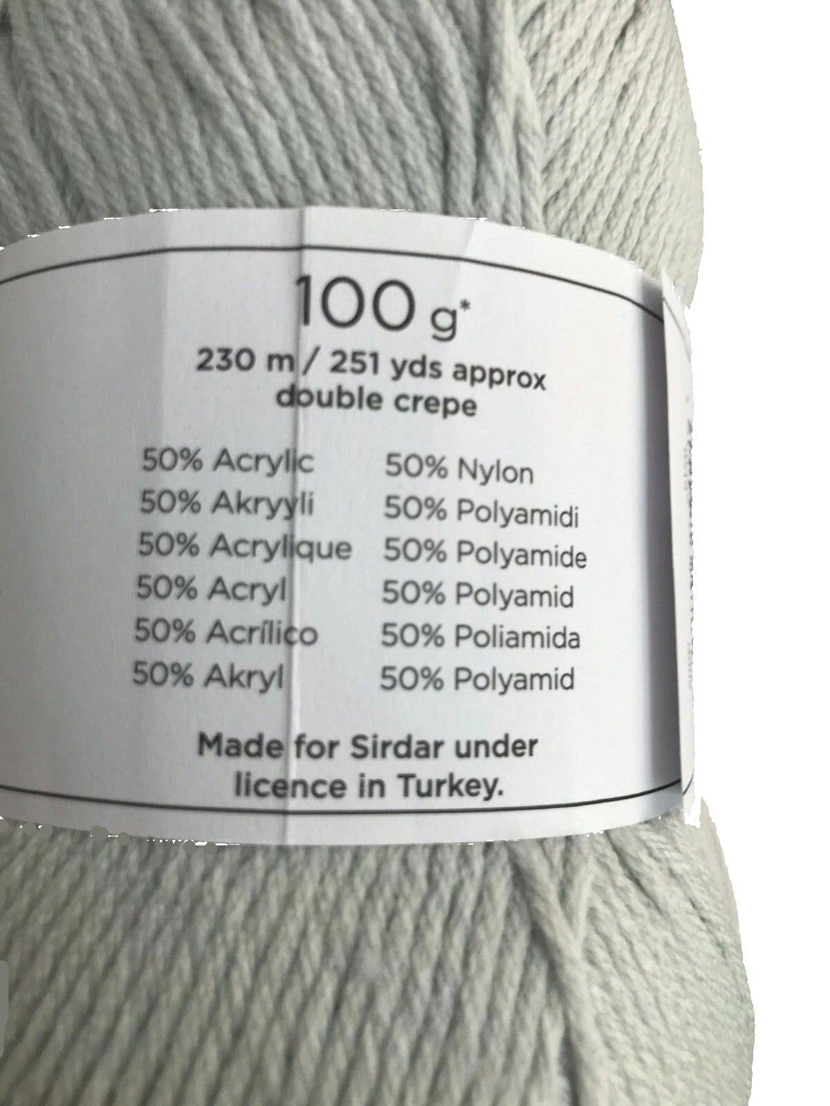 Ball of yarn with a label detailing fiber content and origin