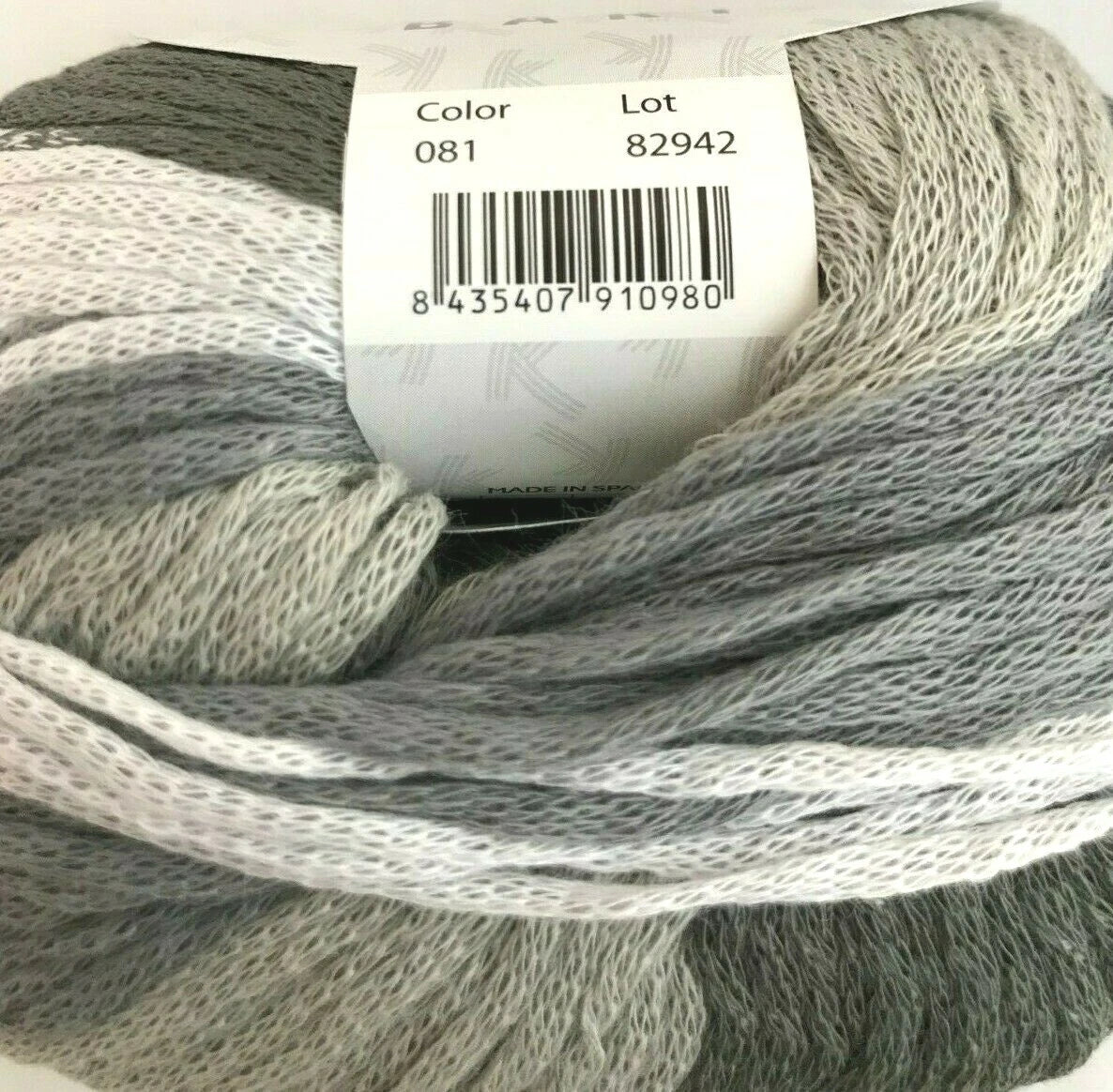 Ball of gray yarn with a label showing color and lot number.