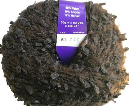 Ball of yarn with a label showing fiber composition and color details on a white background