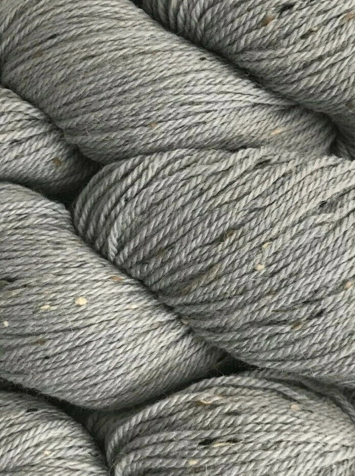 Close-up of gray yarn skeins stacked together