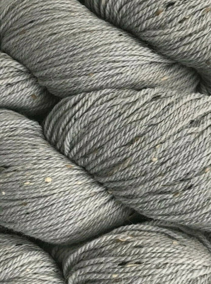 Close-up of gray yarn skeins stacked together