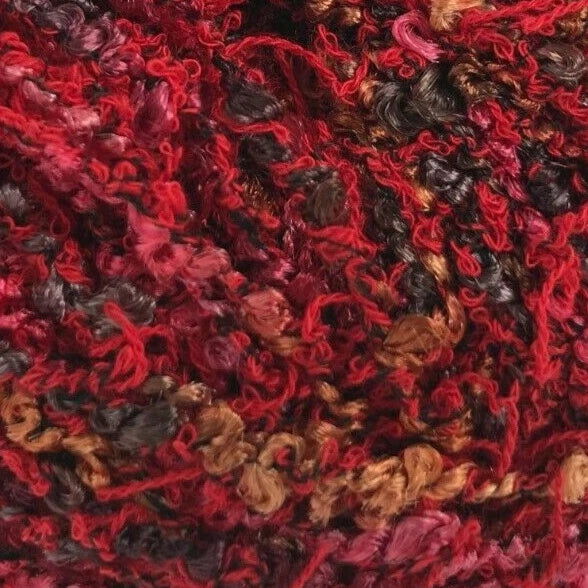 Red and brown yarn ball with a label on a white background