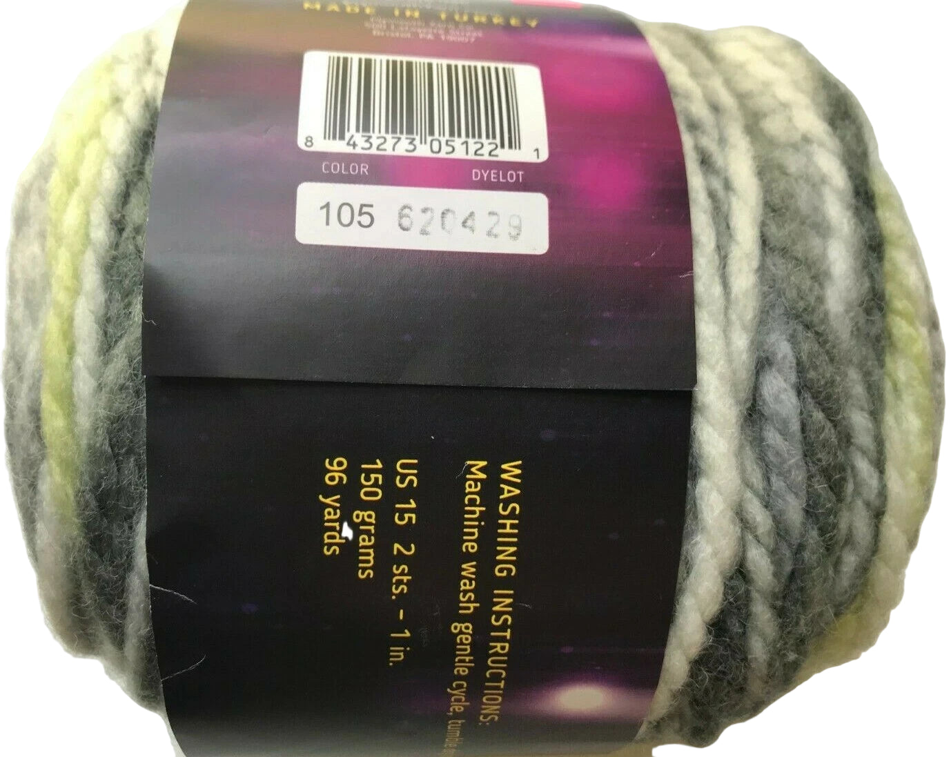 Ball of yarn with a label showing washing instructions and product details.