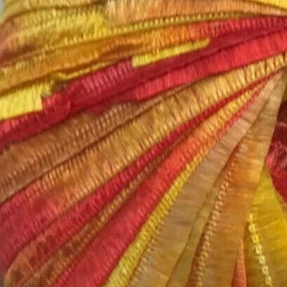 Close-up of colorful fabric with red, orange, and yellow hues.