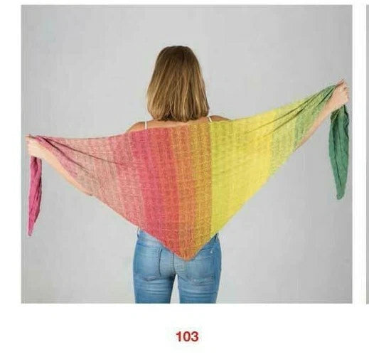 Woman wearing a colorful triangular shawl with a gradient of pink, yellow, and green on a plain background.