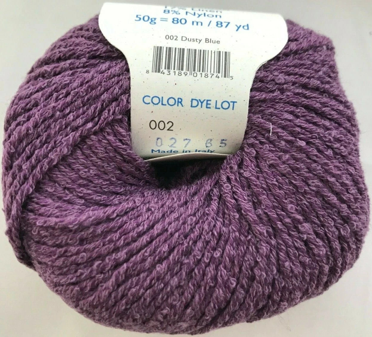 Purple yarn ball with a label on a white background