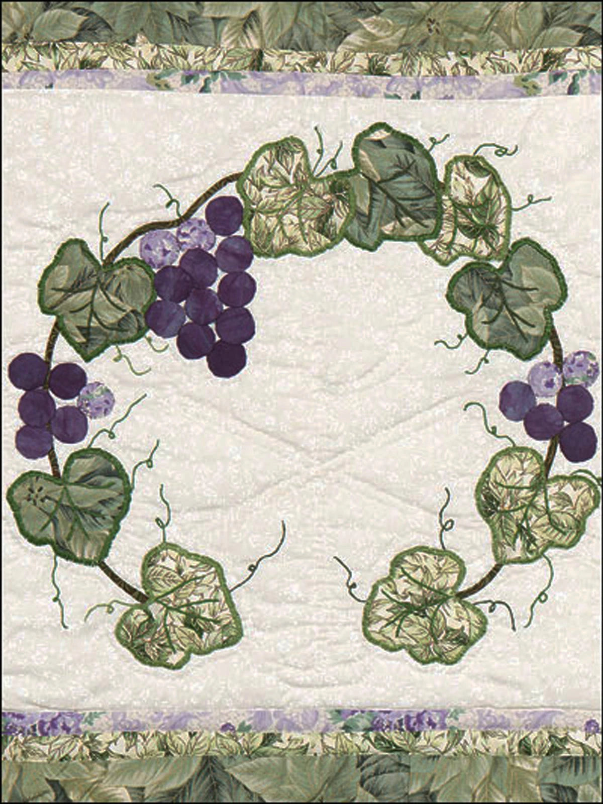 Quilt with grapevine design on a white background