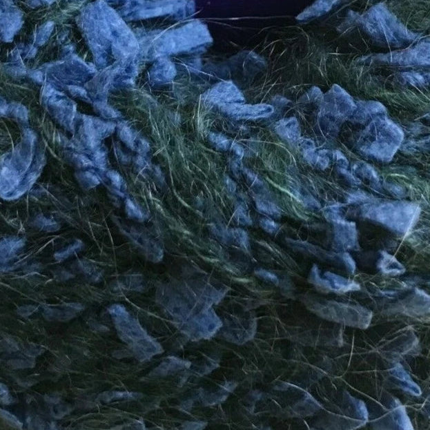 Ball of blue yarn with a label on a white background