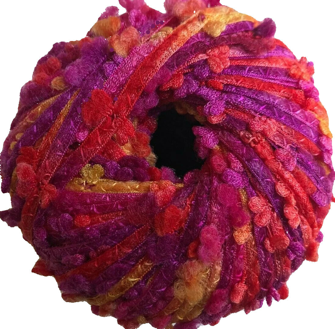 Colorful skein of yarn with a gradient from red to purple on a white background
