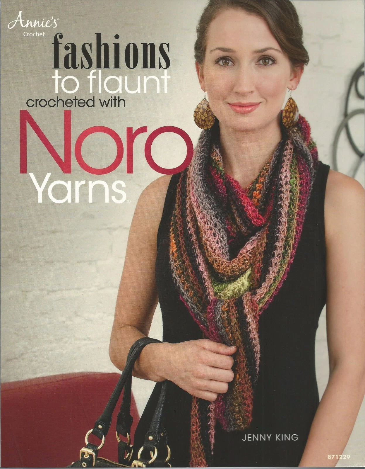 Book cover featuring a woman wearing a colorful scarf with text about Noro Yarns.