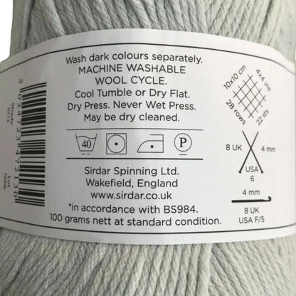 Yarn label with washing instructions and product details on a ball of gray yarn.
