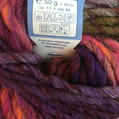 Multicolored yarn with a label indicating weight and care instructions.