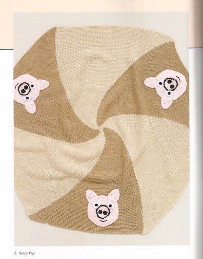 Knitted baby blanket with pig designs on a beige background