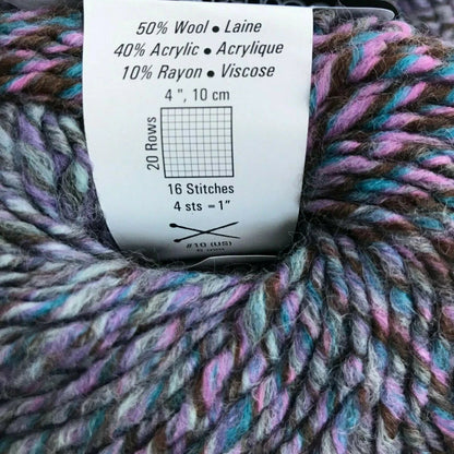 Multicolored yarn with a label showing fiber content and knitting information.