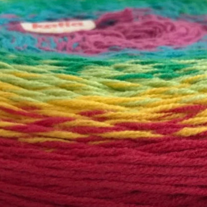 Close-up of a ball of multicolored yarn with a brand label.
