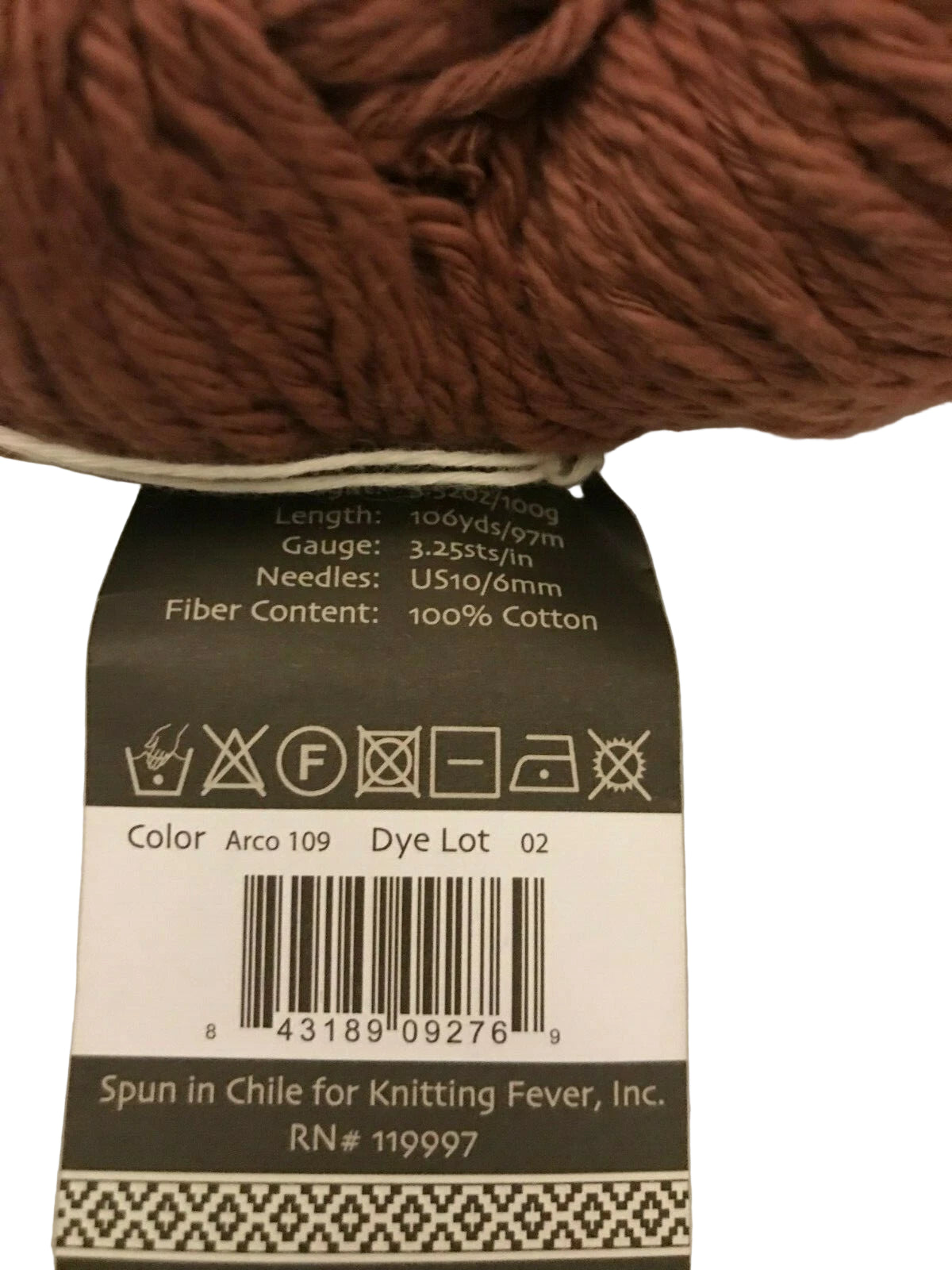 Brown yarn with a label on a beige background