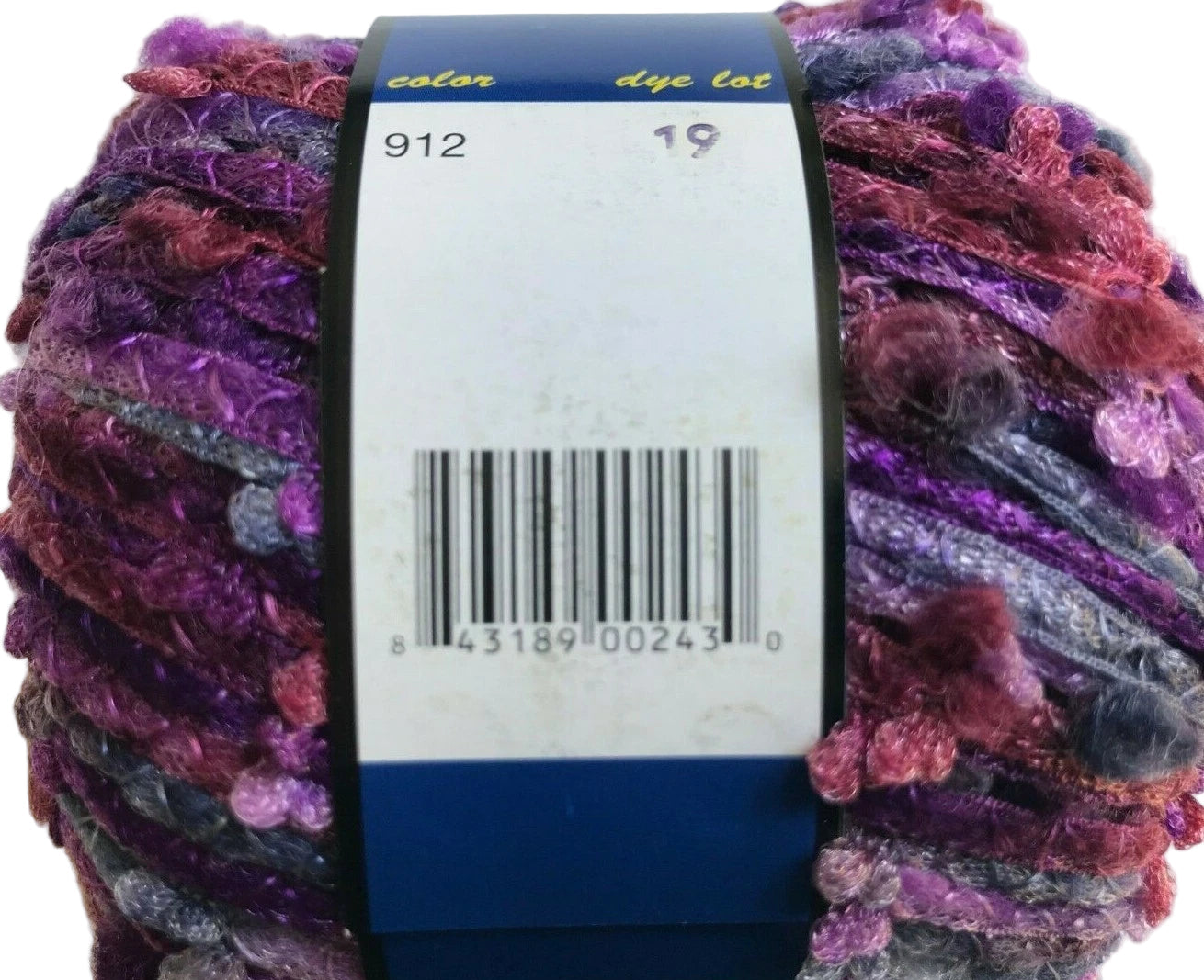 Multicolored yarn ball with a label and barcode on a white background